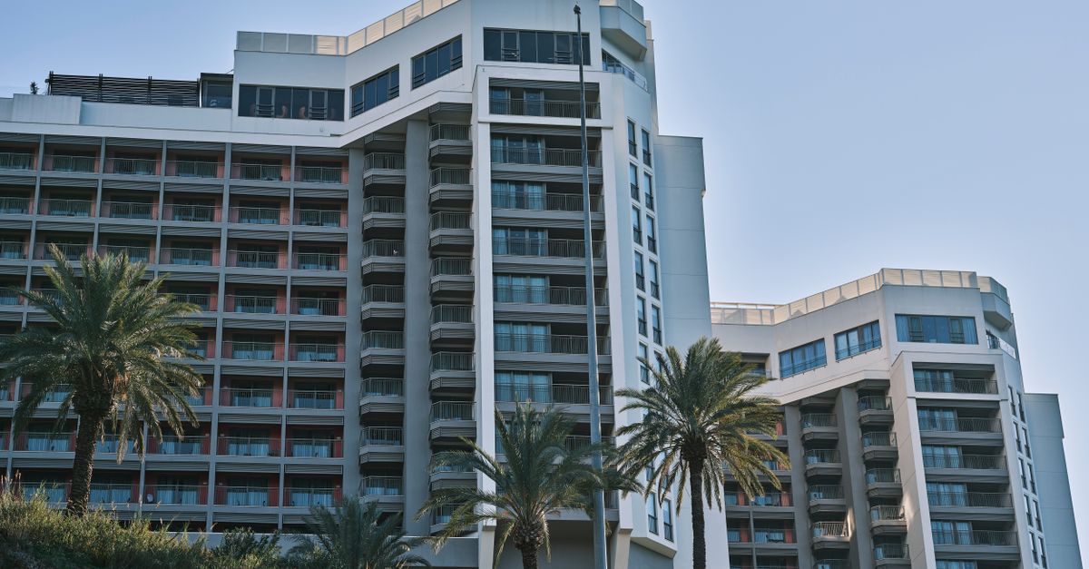 Contemporary hotel building exterior in Antalya, Turkey, featuring modern architecture and palm trees.